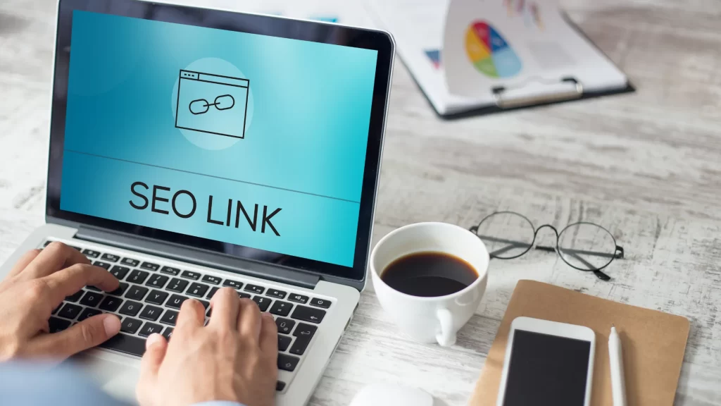 Laptop screen showing SEO Link icon with a person typing