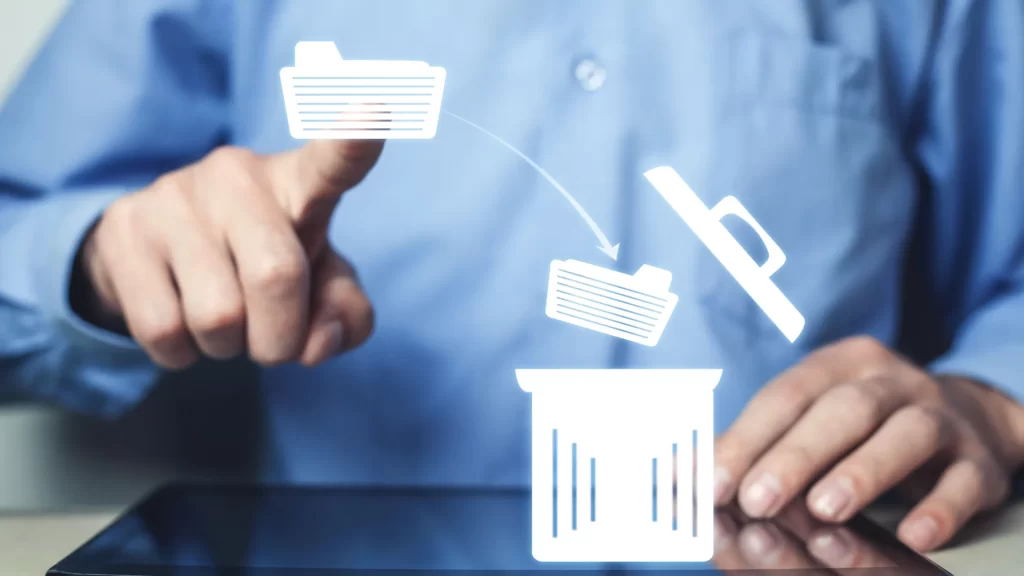 User deleting files from a tablet, symbolic of deleting a page on Confluence.
